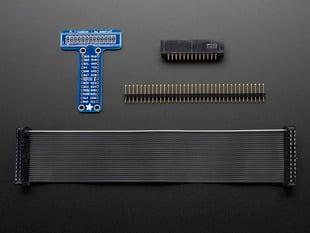 Kit contents for Adafruit Pi Unassembled T-Cobbler Breakout, including T-Cobber breakout, box header, male header, and black GPIO ribbon cable