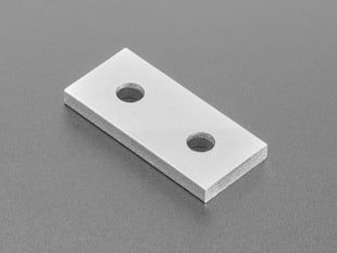 Angled shot of aluminum, rectangular, 2-holed coupling plate.
