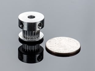 Aluminum Timing Pulley next to quarter