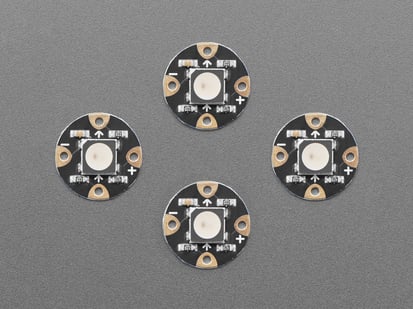 Flora RGB Smart NeoPixel version 3 - Pack of 4 - Overhead shot of four, black, round LED breakouts.