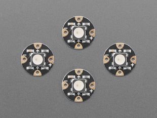 Overhead shot of four, black, round LED breakouts.