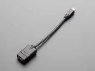 Angled shot of 7" long, black, micro-HDMI to HDMI socket adapter cable.