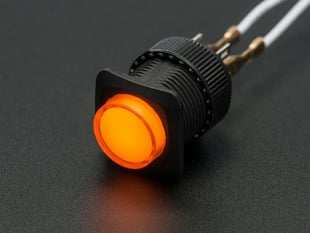 Angled shot of a yellow round 16mm illuminated pushbutton. 