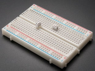2 white 6mm tactile switch buttons on a breadboard.