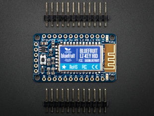 Top view shot of Bluefruit EZ-Key - 12 Input Bluetooth HID Keyboard Controller between 2 12-pin headers.