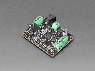 Angled shot of stereo amplifier board with green terminal blocks.