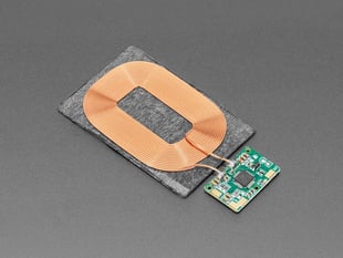 Angled shot of rectangular Qi wireless receiver module and PCB.