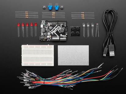 Budget Pack for Metro 328 - with Assembled Metro ATmega328P - Budget pack kit contents, microcontroller board, breadboard, wires, and parts.