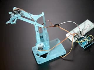 Robot arm moving around and opening/closing the grabber.