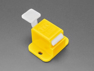 Angled shot of a yellow Fixture Clip. 