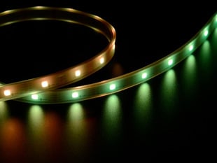 Angled shot of LED strip emitting orange and green lights.