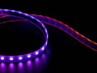 Angled shot of LED strip emitting purple and red lights.