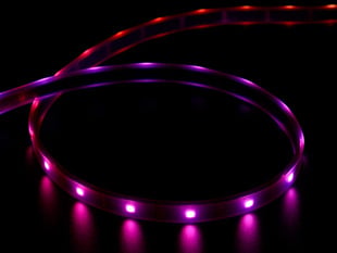 Angled shot of lit RGBW LED strip with red and purple lights.