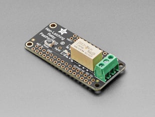 Angled shot of an Adafruit Non-Latching Mini Relay FeatherWing. 

