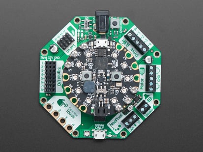 Adafruit CRICKIT for Circuit Playground Express - Top down view of a Adafruit CRICKIT for Circuit Playground Express with a circular board connected. 