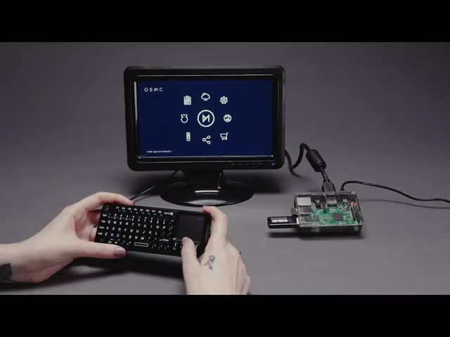 Raspberry Pi Media Center Kit for Raspberry Pi3 - No Pi Included - Video of a fully assembled kit and white hands holding USB mini keyboard while scrolling through the options on the display. 