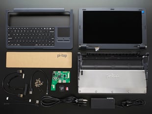 Un-assembled laptop kit with components, cables, and laptop body
