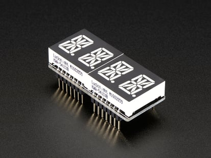 Adafruit 0.54" Quad Alphanumeric FeatherWing Display - Red - Angled shot of a rectangular shaped Quad Alphanumeric Display breakout board with an LED matrix soldered on.