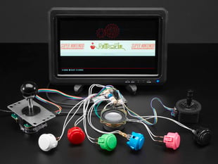 Six arcade buttons, two joystick controllers, and a speaker wired up breakout board and a mini HDMI monitor, which shows a game emulator menu.