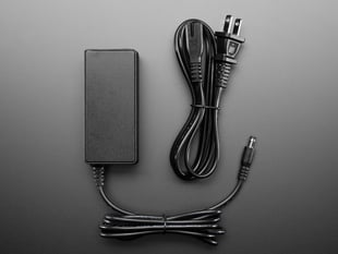 Power brick with coiled cables.