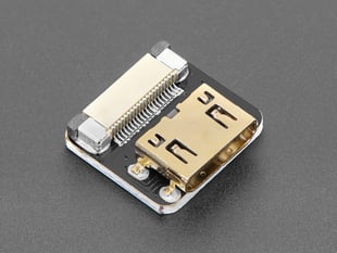 Angled shot of a small, square, mini HDMI socket adapter.