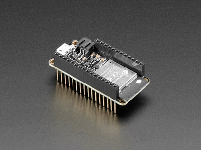 Assembled Adafruit HUZZAH32 – ESP32 Feather Board - with Stacking Headers - Angled shot of an Assembled Adafruit HUZZAH32 – ESP32 Feather Board - with Stacking Headers
