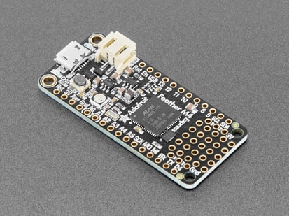 Adafruit Feather M4 Express - Featuring ATSAMD51 - ATSAMD51 Cortex M4 - Angled shot of a Adafruit Feather M4 Express. 