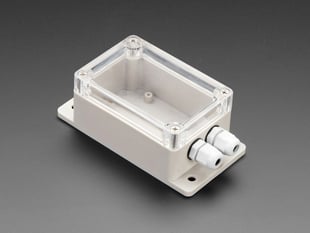 Angled shot of off-white, rectangle-shaped, flanged enclosure.