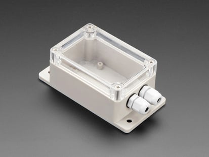 Flanged Weatherproof Enclosure With PG-7 Cable Glands - Angled shot of off-white, rectangle-shaped, flanged enclosure.