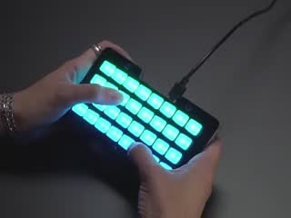 Demo Video of Hands pressing buttons on lit up NeoTrellis M4.