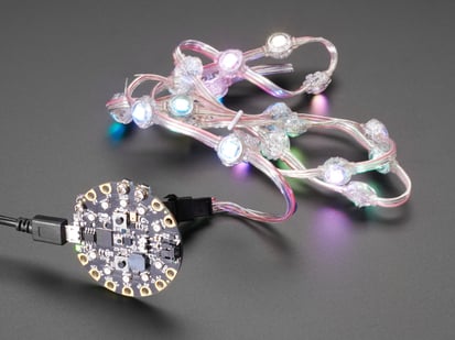 Bolt-On Kit for Circuit Playground, micro:bit, Flora or Gemma - Close up angled shot of a LED strip attached and powered by a circuit playground. 