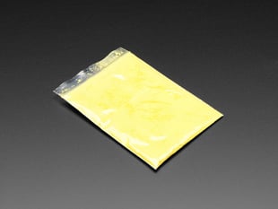 Angled shot of clear baggy containing yellow thermochromic pigment powder.