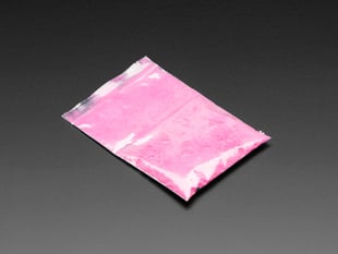 Angled shot of clear baggy containing pink thermochromic pigment powder.