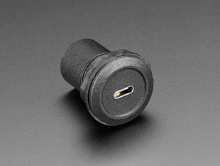 Angled shot of a black, round, panel mount adapter with a USB-C socket.