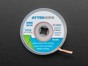 Spool of solder wick with a 0.8mm wide wick coming out.