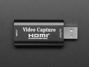 Overhead shot of black USB-A-to-HDMI video capture adapter.
