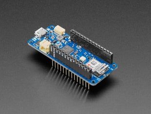 Angled shot of blue, rectangular microcontroller with stacking headers.