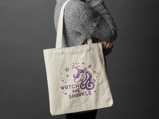 Person with completed DIY Watch Me Sparkle Light-Up Tote Bag Kit slung over sholder
