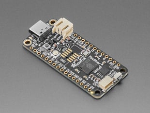 Angled shot of black rectangular microcontroller "Feather RP2040"