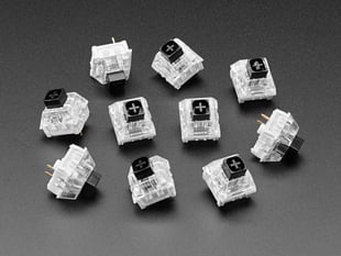Angled shot of ten black Kailh key switches.