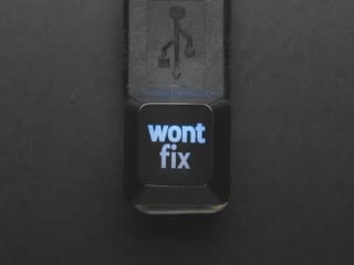 Top view video of black wontfix keycap connected via USB cable. Various colors emit through the logo.