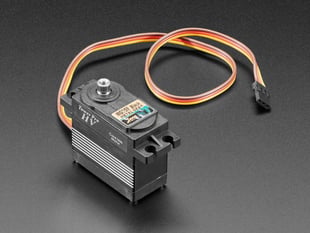 Angled shot of black servo motor with 3-pin jumper cable.