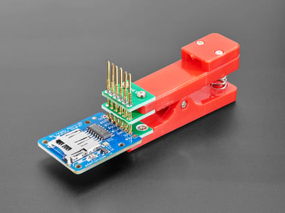 Pogo Pin Probe Clip - 6 Pins with 2.54mm / 0.1" Pitch - Pogo Pin Probe Clip clipped onto a PCB with six pins.