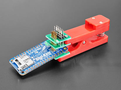 Pogo Pin Probe Clip - 2x5 1.27mm Pitch SWD - Pogo Pin Probe Clip clipped to a PCB with 2x5 pads.