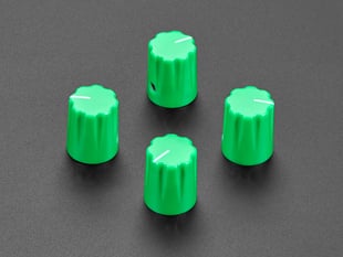 Angled shot of four green plastic micro knobs.