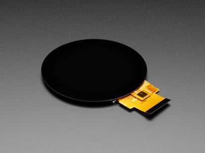 Round RGB 666 TTL TFT Display - 2.1" 480x480 - Capacitive Touch - TL021WVC02CT-B1323 - TL021WVC02CT-B1323 - Angled shot of round TFT display with 40-pin cable ribbon.