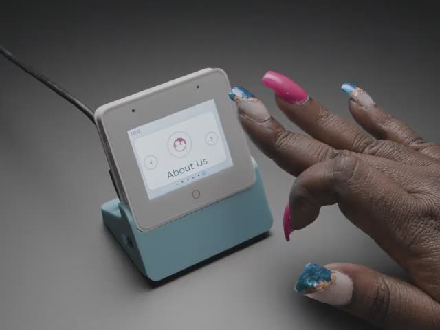 Espressif ESP32-S3-BOX-3 - Video of a Black woman's manicured hands manipulating the touchscreen on a small square-shaped LCD module.