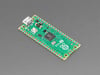 Angled shot of thin, green rectangular microcontroller with castellated pads.
