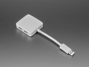 Angled shot of white, square-shaped USB hub.