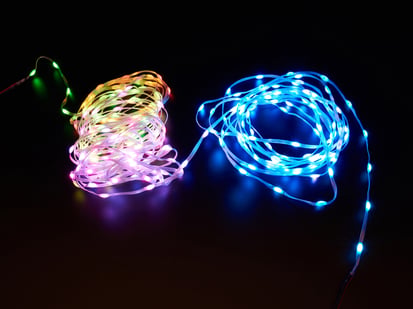 Adafruit NeoPixel Pebble / Seed LED Strand - 300 LEDs - 2" Pitch - 15 meters long - 15 meters long - Pebble strand LED strips lit up yellow-pink and blue.